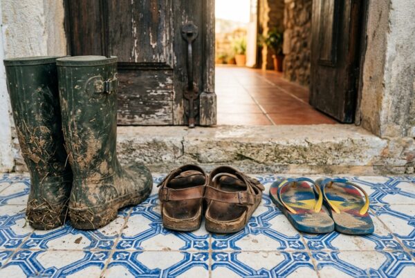 A row of shoes left at the entrance of a Portuguese home_ seen from above at a sligh