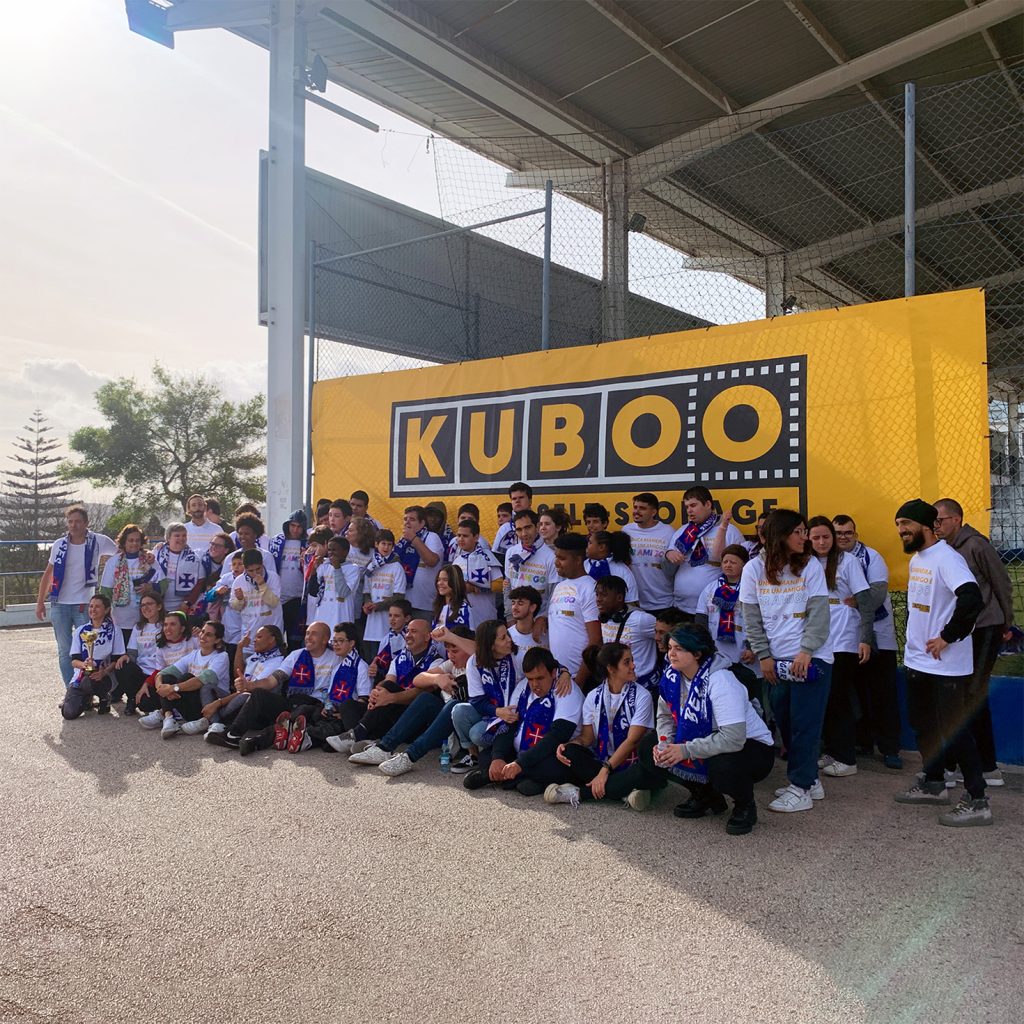 many kids in front of a kuboo flag