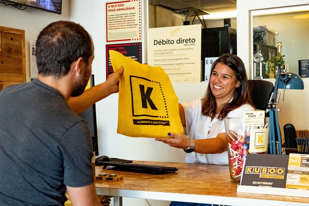 kuboodista a oferecer merchandise kuboo a um cliente