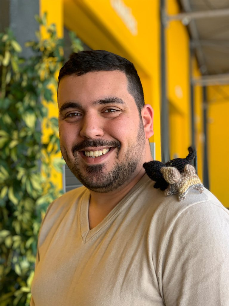 TWO WOOL DOLLS ON A KUBOODISTA'S SHOULDER IN KUBOO CARNAXIDE